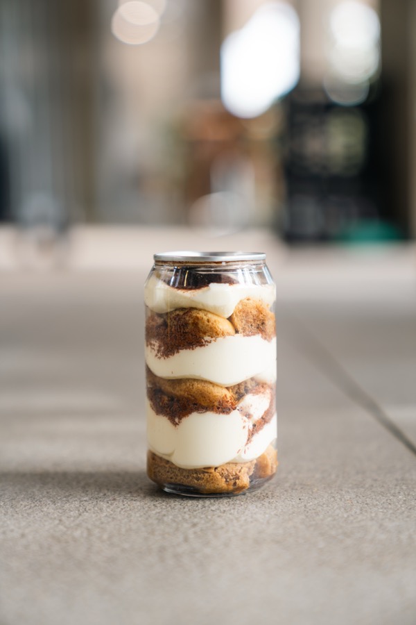 An individual breakfast chia cup layered with yoghurt and granola